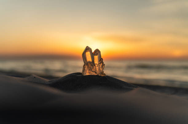 Healing crystal therapy by the sea. Crystal illuminated by the setting sun