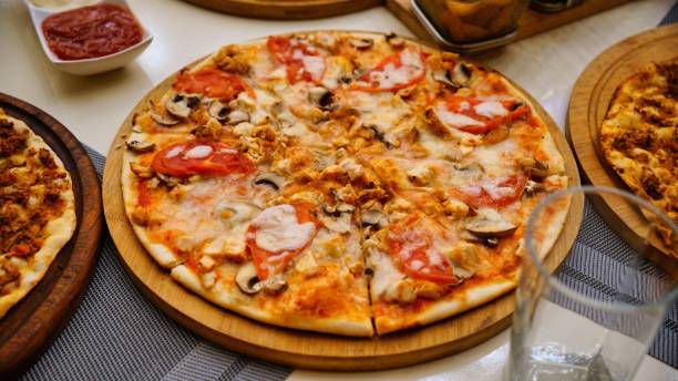 istock Chicken and Mushroom Pizza on Wooden Board 2166032011