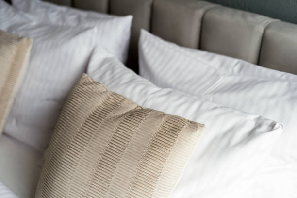 istock Close up of bed with decorative cushions and white pillows 2166032407