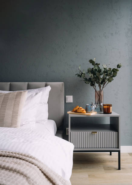 istock Bedroom with bed and breakfast tray on nightstand with plant 2166032412