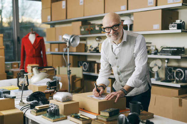 istock Seller writing the address on a delivery box 2166033228