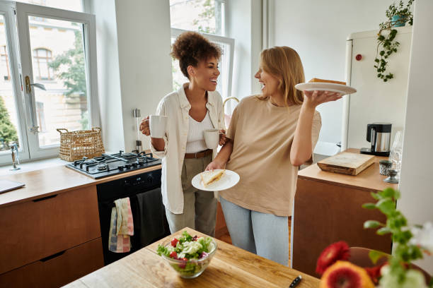 istock Cheerful multicultural couple joyfully preparing breakfast together in a cozy kitchen 2166034744
