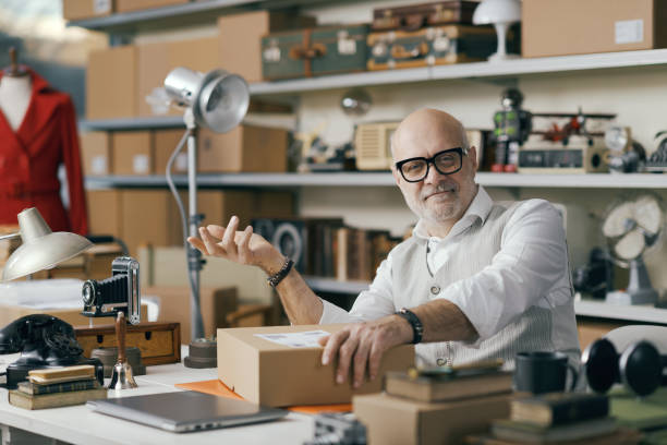 istock Collector selling vintage and second-hand objects in his shop 2166034829