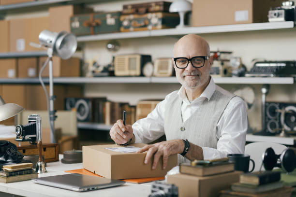 istock Seller writing the address on a delivery box 2166034834