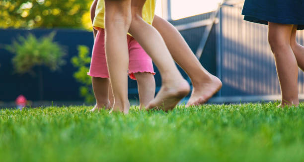 istock Children's legs run on green grass. children. 2166036222