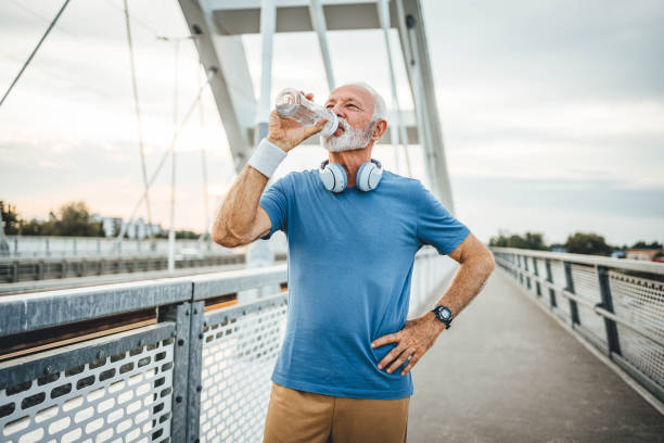 istock Senior man drinking water during workouts outdoors 2166036540