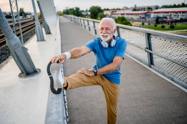 istock Senior man doing stretching before exercising on the bridge 2166037070