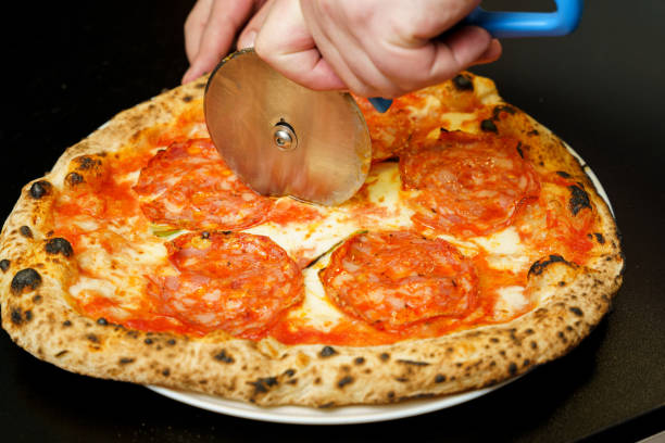 istock Italian salami and cheese pizza being sliced 2166039531
