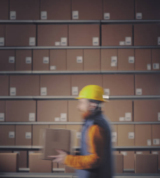 istock Warehouse worker and boxes on the conveyor belt 2166041369