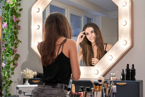 istock Brunette woman looking in makeup mirror 2166041568