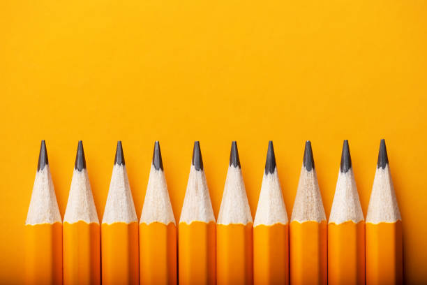 Abstract background of yellow pencils lying in a row