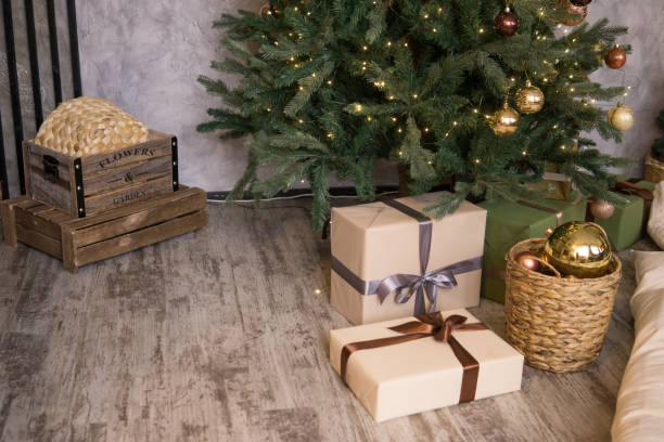 istock Bronze balls on the Christmas tree close-up. Gift boxes under the tree. The concept of celebrating New Year and Christmas 2166041795