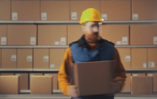 istock Warehouse worker and boxes on the conveyor belt 2166043152