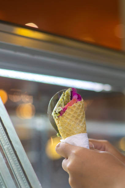 istock Person holding cone of ice cream 2166043233