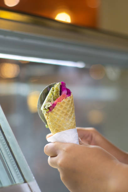 istock Person holding cone of ice cream 2166043337
