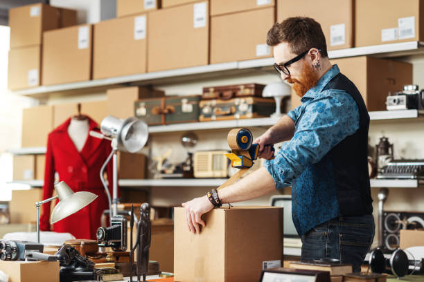 istock Store owner taping a delivery box 2166043452