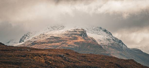 istock Scenic Scottish Highlands disappearing into misty mountains, with dense foliage on either side 2166045276