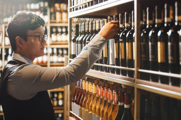 istock Expert Sommelier Selecting Fine Wine From Cellar Shelf During Evening Service 2166045643