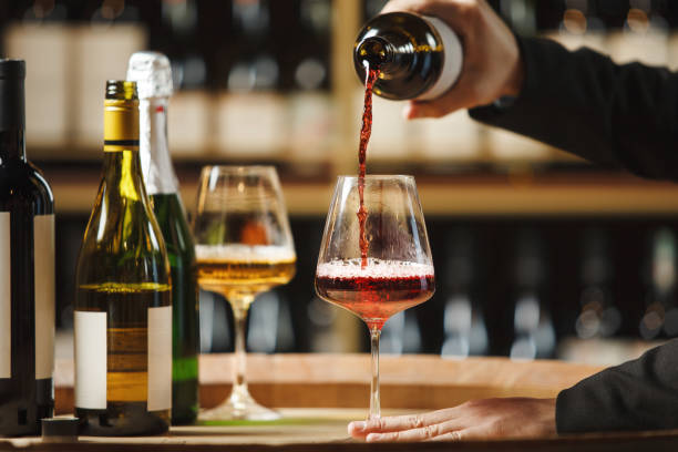 istock Unrecognizable Sommelier Pouring Red Wine in Wine Cellar 2166046214