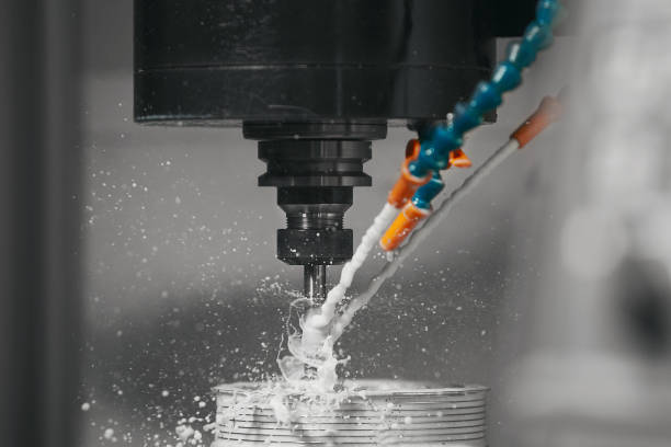 istock Metalworking CNC machine drilling with coolant. Metal machine industry concept. 2166046529
