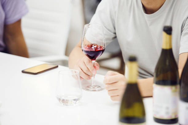 istock Wine experts association, sommelier school, professional development. Sommelier tasting red wine from glass, analysing its taste, color, smell and acidity level. 2166047409