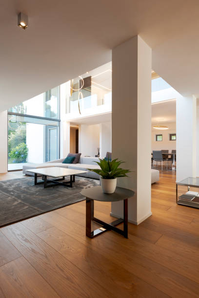 istock Modern living room with large sofa, with chaise longue, central coffee table, above a large carpet. Interior of a modern house on two levels 2166048214