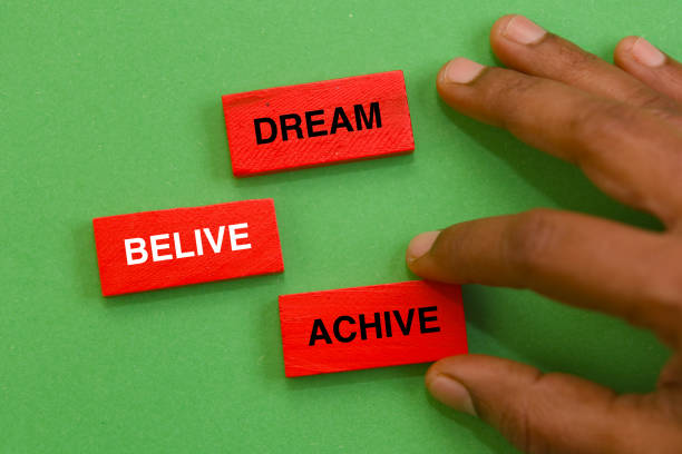 Unlock your potential! Colorful blocks spell out the path to success, held against a vibrant green background.