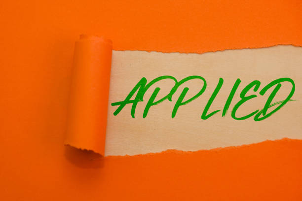 Vibrant orange torn paper reveals APPLIED in bold green letters, signifying success and accomplishment.