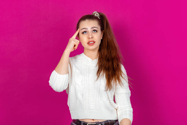 istock Thoughtful Woman Contemplating a Problem, Finger on Temple. Conceptual Image Reflecting Deep Thinking, Decision Making and Problem Solving. Ideal for Business, Education and Mental Health Visual 2166054199