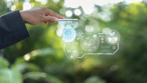 istock A hand holding a phone with a screen that shows a green planet with a blue circl 2166055204