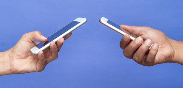 istock Two Hands Holding Mobile Phones 2166056682
