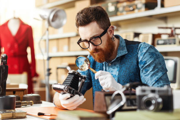 istock Collector checking vintage items in his store 2166058255