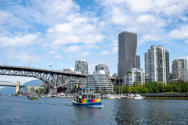 City skyline, ferry and calm bay, from Granville Street Bridge to Burrard Street Bridge, Vancouver