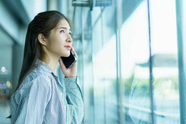 istock Asian young woman checking a flight schedule on an application on smartphone. 2166059498