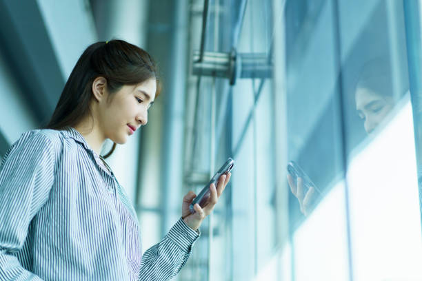 istock Asian young woman checking a flight schedule on an application on smartphone. 2166059505
