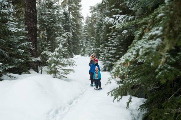 istock Family snowshoes through forest 2166059733