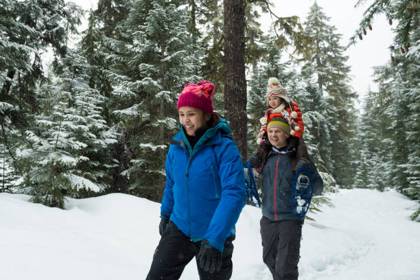 istock Family snowshoes through forest 2166059857