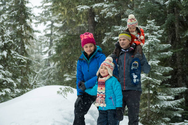 istock Family snowshoes through forest 2166059859
