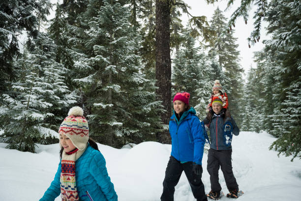 istock Family snowshoes through forest 2166059860