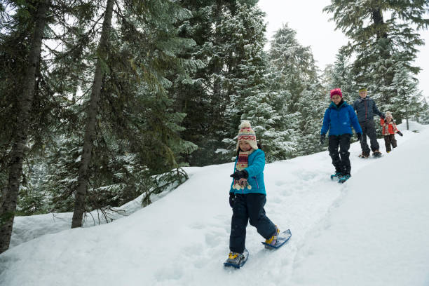 istock Family snowshoes through forest 2166059943