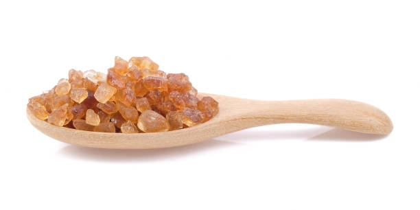 istock Rock sugar on wooden spoons close up on white background. 2166060450