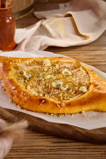 istock Traditional Georgian Khachapuri with Blue Cheese and Walnuts on Rustic Wooden Table 2166063341