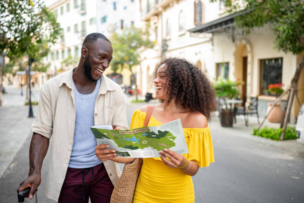 istock Happy couple traveling and looking at a map for directions 2166065255