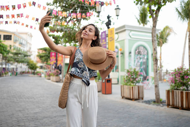 istock Happy female influencer taking a selfie while traveling 2166065323