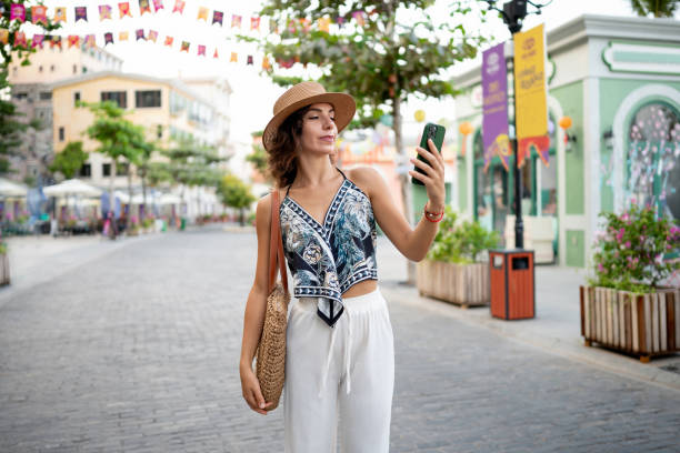 istock Tourist walking outdoors and using the GPS on her cell phone 2166065334