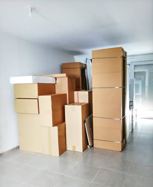 istock Empty room with cardboard boxes on the floor. Moving house. New kitchen delivery and installation 2166069781