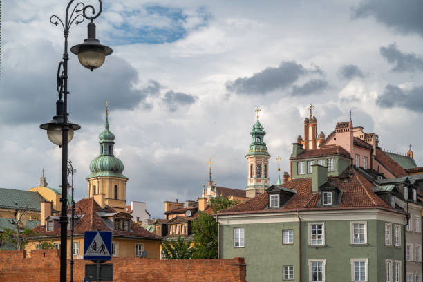 25.07.2024 Warsaw, Poland. The picturesque skyline of Warsaw's Old Town features charming historic buildings and church towers against a backdrop of dramatic clouds. This view captures the essence of the city's architectural heritage and vibrant atmosphere.