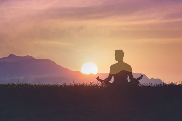 istock Men meditating outdoors in the morning at sunrise. 2166071928
