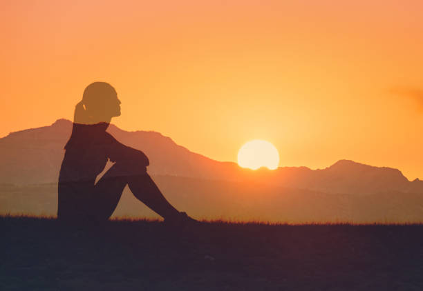 Woman enjoying beautiful sunset.