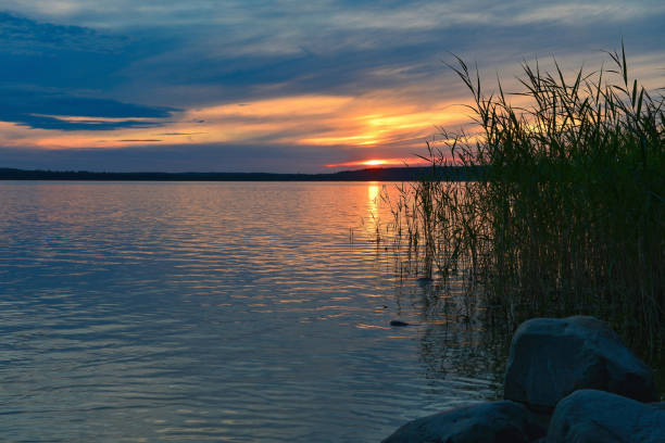 Summer orange sunset with beautiful reflection in the water.